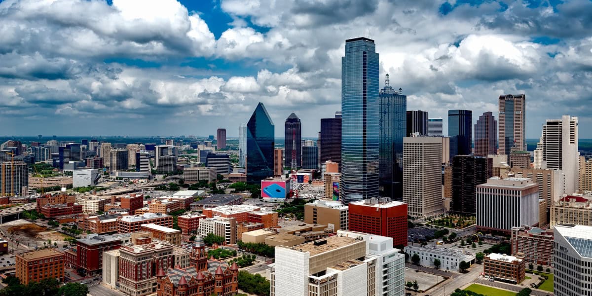 Aerial view of a bustling smart cityscape with skyscrapers under a cloudy sky, enhanced by a cutting-edge digital platform for seamless urban navigation.