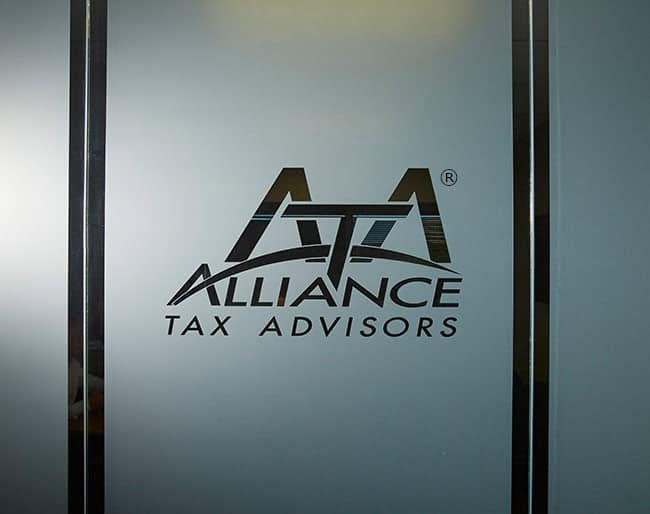 Logo on frosted glass reading Alliance Tax Advisors with stylized letters ATA.